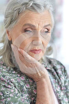 Beautiful sad elderly woman close-up