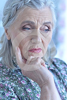 Beautiful sad elderly woman close-up