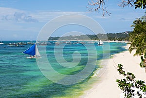 Beautiful sailboat near white sand beach in Boracay