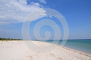 Beautiful sand beach with tourists on the Dzharylhach uninhabited island in the Black sea