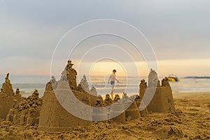 Beautiful sand castle on the sea shore. Sandcastle, built by the children, is close up and a large one.