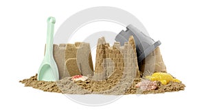 Beautiful sand castles, shells and plastic beach toys on white