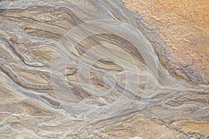 Beautiful sand patterns on the shore of baltic sea. Abstract, colorful background of sand on the beach.