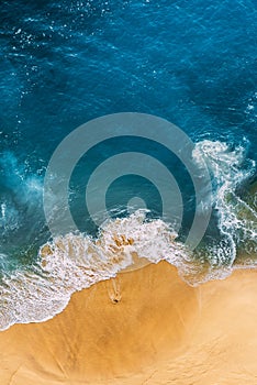 Beautiful sandy beach with blue, vertical view. Drone view of tropical blue ocean beach Nusa penida Bali Indonesia.