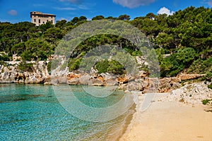 Beautiful sandy beach Cala Gat with clear blue waters and natural surroundings