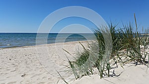 Beautiful sandy beach with clear blue water and blue sky, Island of Bornholm in Denmark