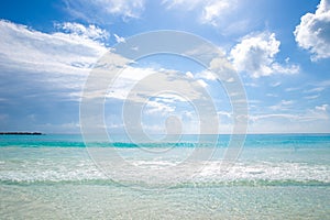 Beautiful sandy beach with people relaxing in a resort in Cancun, Mexico. Summer and sunshine.