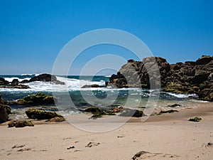 Beautiful sandy beach with rocks in Portugal in summer