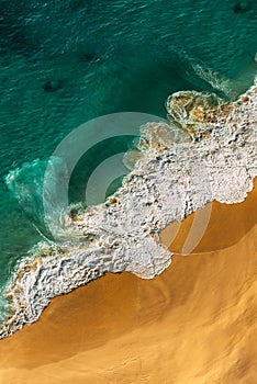 Beautiful sandy beach with turquoise ocean, vertical view. Drone view of tropical turquoise ocean beach Nusa penida Indonesia. 