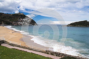 Beautiful sandy beach with view on monte igueldo / igeldo in san sebastian, spain photo