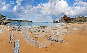 Beautiful sandy Playa Del Portio Biskaya, Cantabria, Spain summer landscape. Atlantic Ocean coastline view with rock formations photo