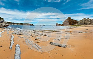 Beautiful sandy Playa Del Portio Biskaya, Cantabria, Spain summer landscape. Atlantic Ocean coastline view with rock formations photo