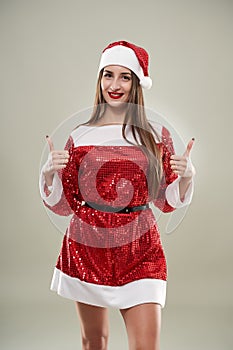 Beautiful Santa helper on gray background