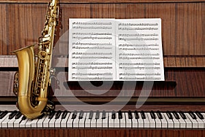 Beautiful saxophone on piano keys. Musical