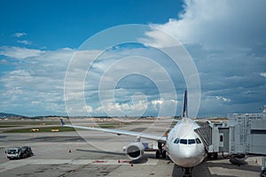 Beautiful scene of aircraft dock for passenger in Zurich Kloten airport on blue sky with cloud background