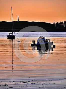 Beautiful scene of boats with reflection at sunset, Oban, Scotland