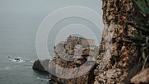 Beautiful scene of the rocky Fort of Sao Miguel Arcanjo by sea in Portugal photo