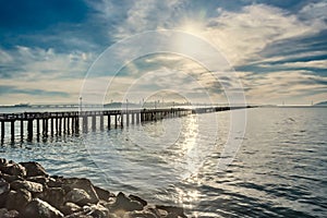 Beautiful scene of San Francisco Bay over shiny water at sunset o the horizon