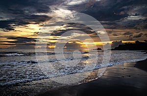 Beautiful scene of a shore washed up by the waves at the sunet