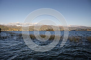 Beautiful scene of sumer sunted colombian lake with forest and mountains