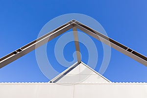 Beautiful scene of Triangular roof frame against Clear blue sky background in town