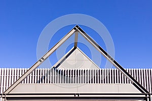 Beautiful scene of Triangular roof frame against Clear blue sky background in town