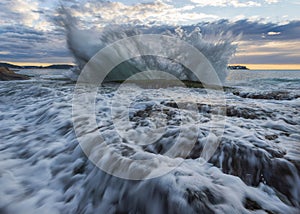 Beautiful scene of Umina Point splash waves on Central Coast in Australia with horizon sunset sky