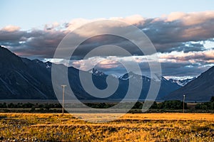 Beautiful scene of the yellow grassland mt cook beside lake tekapo before sunset. I