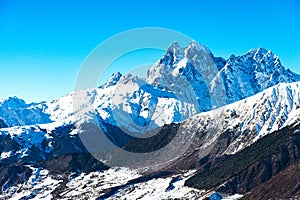 Beautiful sceneric view of Caucasus mountain. The way to mountain with pine forest covered with snow in winter season at Mestia