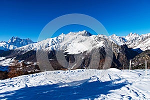 Beautiful sceneric view of Caucasus mountain. The way to mountain with pine forest covered with snow in winter season at Mestia