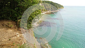 Beautiful scenery of the cliff beside the black sea with azure water in the daytime under the sunshine. Tuapse, Russia.