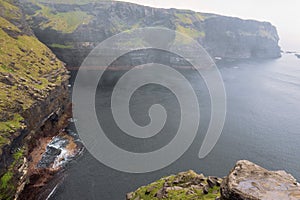 Beautiful scenery of Cliff of Moher, county Clare, Ireland. Fog over water, Nobody. Calm surface of Atlantic ocean