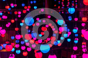 Beautiful scenery of colorful illuminated lanterns hanging from a ceiling in a wedding hall