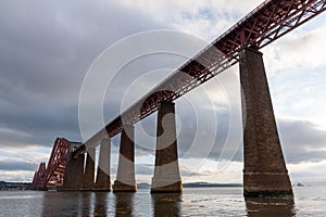 Beautiful scenery of the famous Forth Bridge railway in Queensferry, UK under a cloudy sky