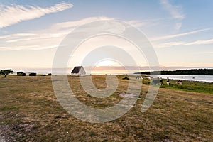 Beautiful scenery Gotland cottage by the sea in sunset