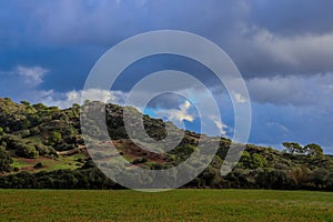 Beautiful scenery of high mountains covered in trees in Menorca, Islas Baleares, Spain