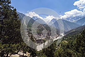 Beautiful scenery of high snow peaked mountain, blue sky and clouds on sunny day.