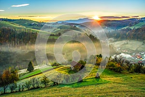 Beautiful scenery landscape Romania village mountains hills fields foggy morning first ray splitting light