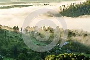 Beautiful scenery landscape sunrise foggy morning village Maramures Romania