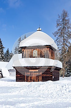 Beautiful scenery with an old wooden building covered in a massive amount of snow.