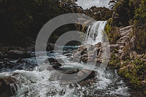 Beautiful scenery of a powerful waterfall in Gollum`s Pool, New Zealand