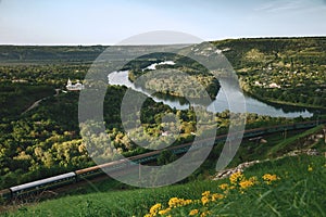 Beautiful scenery of river Dniester and a train