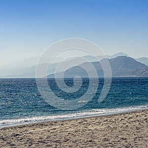 Beautiful scenery of the sea surrounded by the Cretan mountains under the clear sky