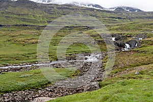 Beautiful scenery and waterfalls, mountains in Iceland, on the mountain pass road from Egilsstadir to Seydisfjordur