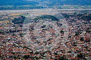 Beautiful scenic cityscape postcard view of ancient red roof buildings, urban street and space in Kalambaka from Meteora