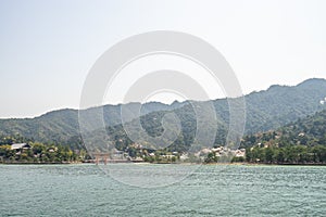 Beautiful scenic green mountain with downtown port village in Miyajima island on Hiroshima, Japan