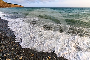 Beautiful scenic landscape of stony beach at Black Sea coast by Anapa, Russia. Wave splashing on the shore making spindrift.