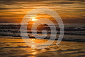 Beautiful scenic panoramic view of a colorful sunset on the beach at the Atlantic Ocean, in north of Spain