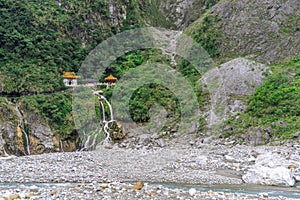 Beautiful scenic of the shrine on the cilff with waterfall down to the river