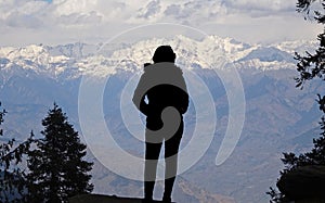 Beautiful scenic Silhouette photo of unrecognizable tourist trekking girl